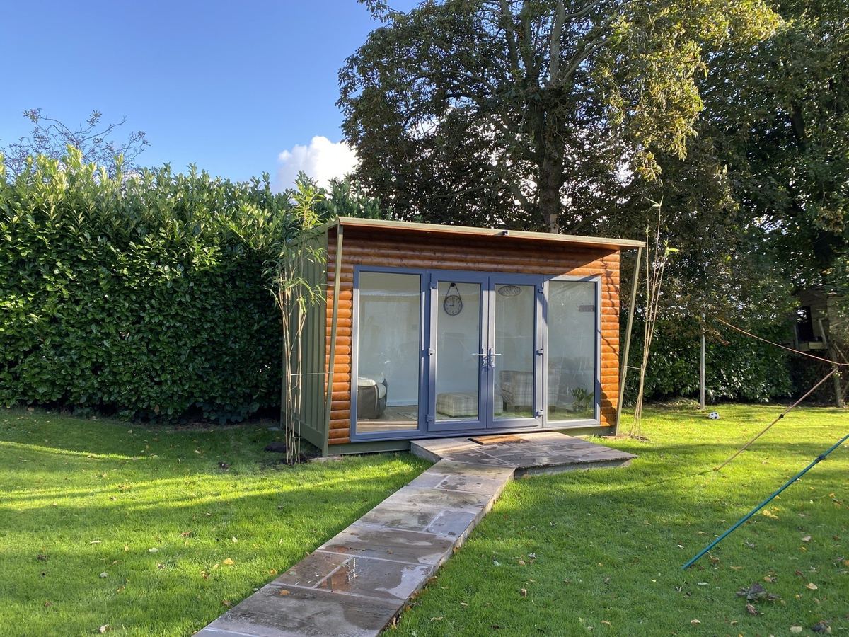 The garden therapy room with its glass doors open, on a sunny day